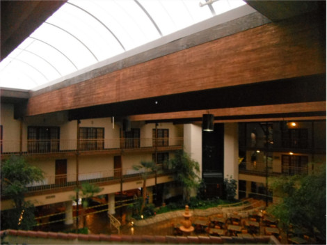 Interior view of a white barrel vault skylight over hotel lobby