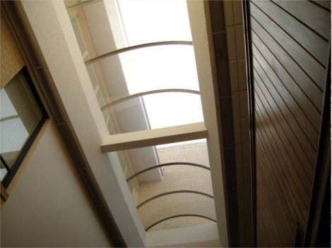 Interior view a bronze barrel vault skylight in a church hallway