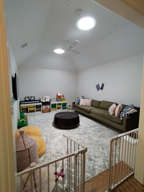 A brightly lit media room after a pair of Sun Tunnel skylights are installed.