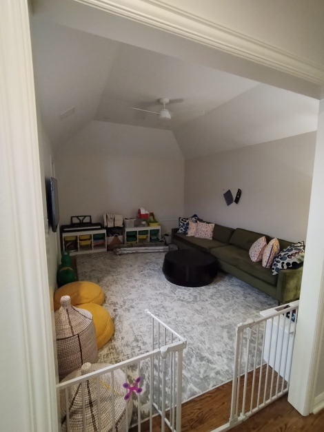 A dimly lit media room before a pair of Sun Tunnel skylights are installed.